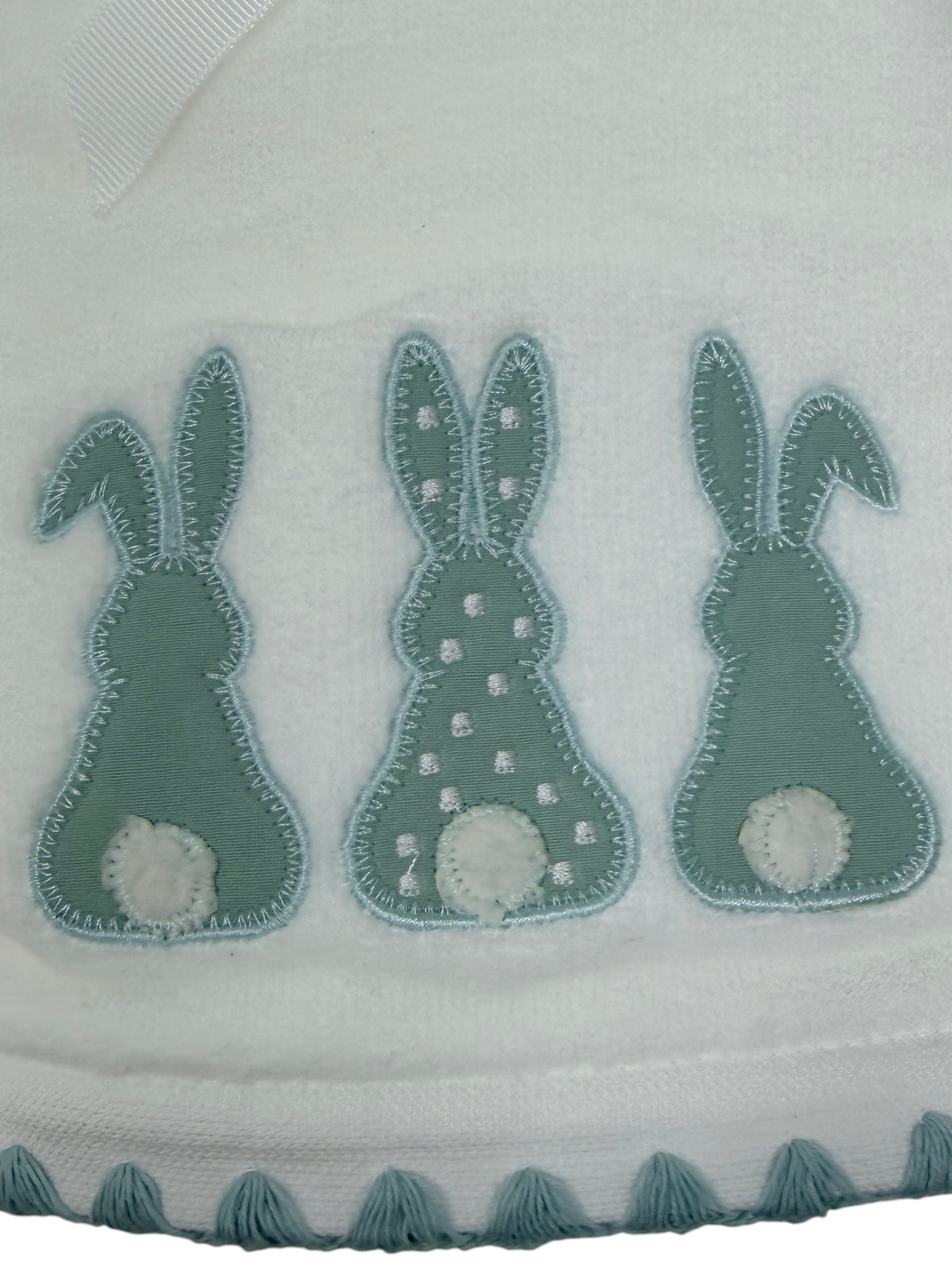 Set of two white hand towels featuring blue applique bunnies with white cotton tails and scalloped border by Caro Home