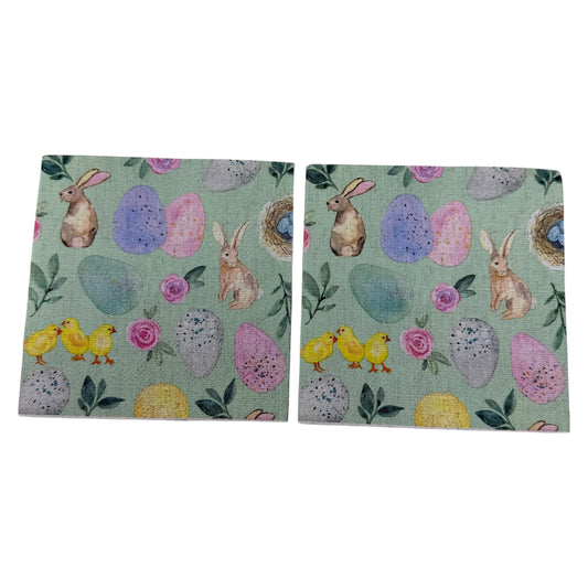 Pastel Easter cocktail napkin featuring bunnies, chicks, eggs, and floral designs on mint green background