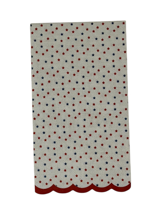 Guest-size decoupage paper napkin featuring a delicate all-over tossed pattern of tiny red and navy blue stars on a soft warm white background with a charming red scalloped edge border, photographed on a white surface.