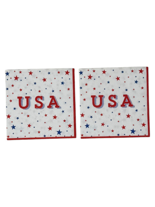 Cocktail size decoupage paper napkin featuring scattered red and blue stars of varying sizes across a bright white background with bold USA typography in red and blue shadow and a crisp red border set of 2