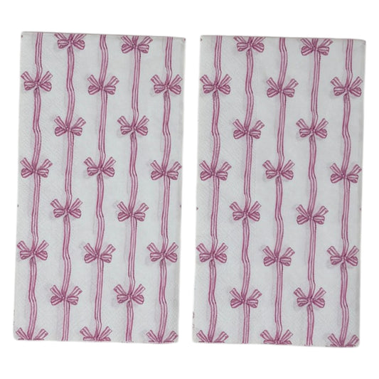 Two guest-size decoupage paper napkins featuring an all-over print of vertical wavy stripes with small striped bows tied at intervals in dusty pink and mauve on a crisp white background, photographed on a white surface.