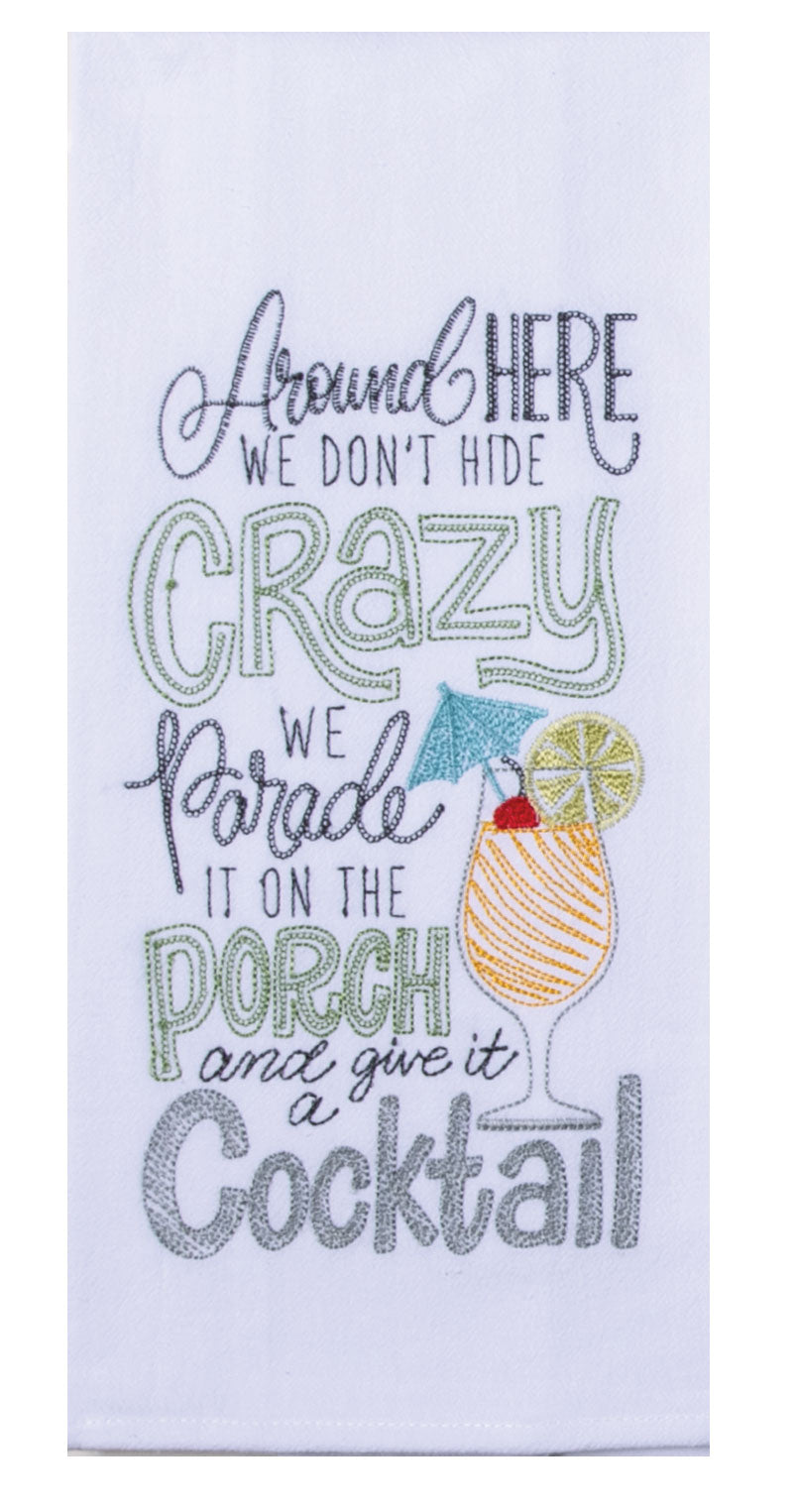 A white kitchen towel with green and blue text, featuring the phrase 'Around here we don't hide crazy, we parade it on the porch with a cocktail' and a cocktail glass with a lime on the front.