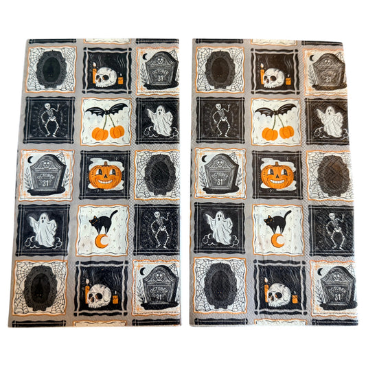 Guest-size decoupage paper napkin featuring a patchwork grid of fifteen individual framed Halloween icons including a skull with candles dancing skeleton friendly ghost grinning pumpkin black cat on crescent moon October 31 tombstone bat cherry and spider webs in black orange and white on a soft grey background