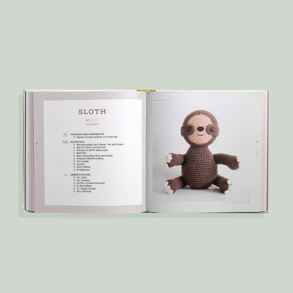 Open book showing a crochet pattern for a sloth toy on a light green background