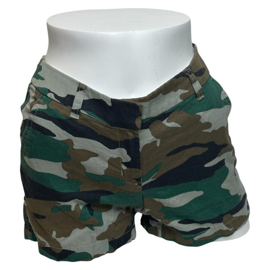Camouflage shorts on a white mannequin against a white background