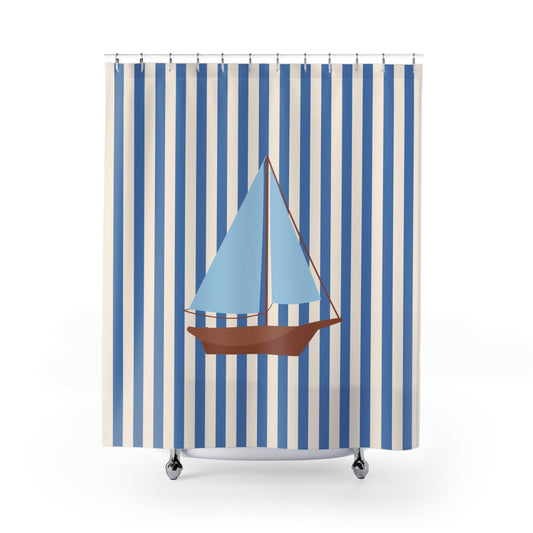 A shower curtain featuring a vertical blue and white stripe pattern with a central illustration of a sailboat with light blue sails and a brown hull, shown hanging from silver hooks against a white background.