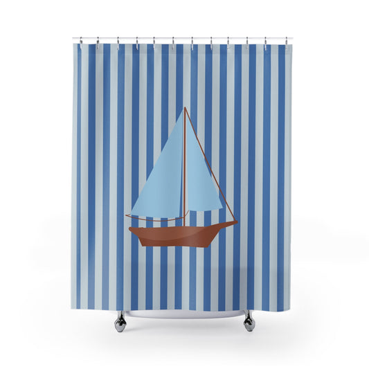 A shower curtain featuring a vertical blue and white stripe pattern with a central illustration of a sailboat with a light blue sail and brown hull, shown hanging from silver hooks against a white background.