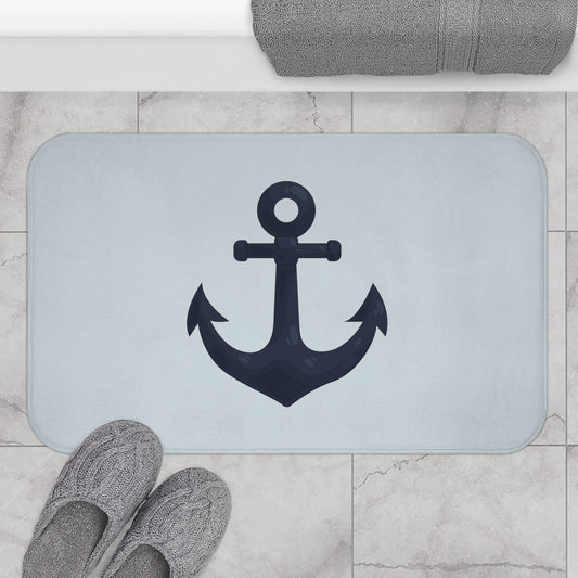 Bath mat with anchor design on a marble floor with slippers and towel.