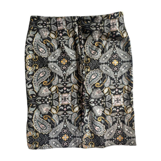 Patterned skirt with a black and gold design on a white background