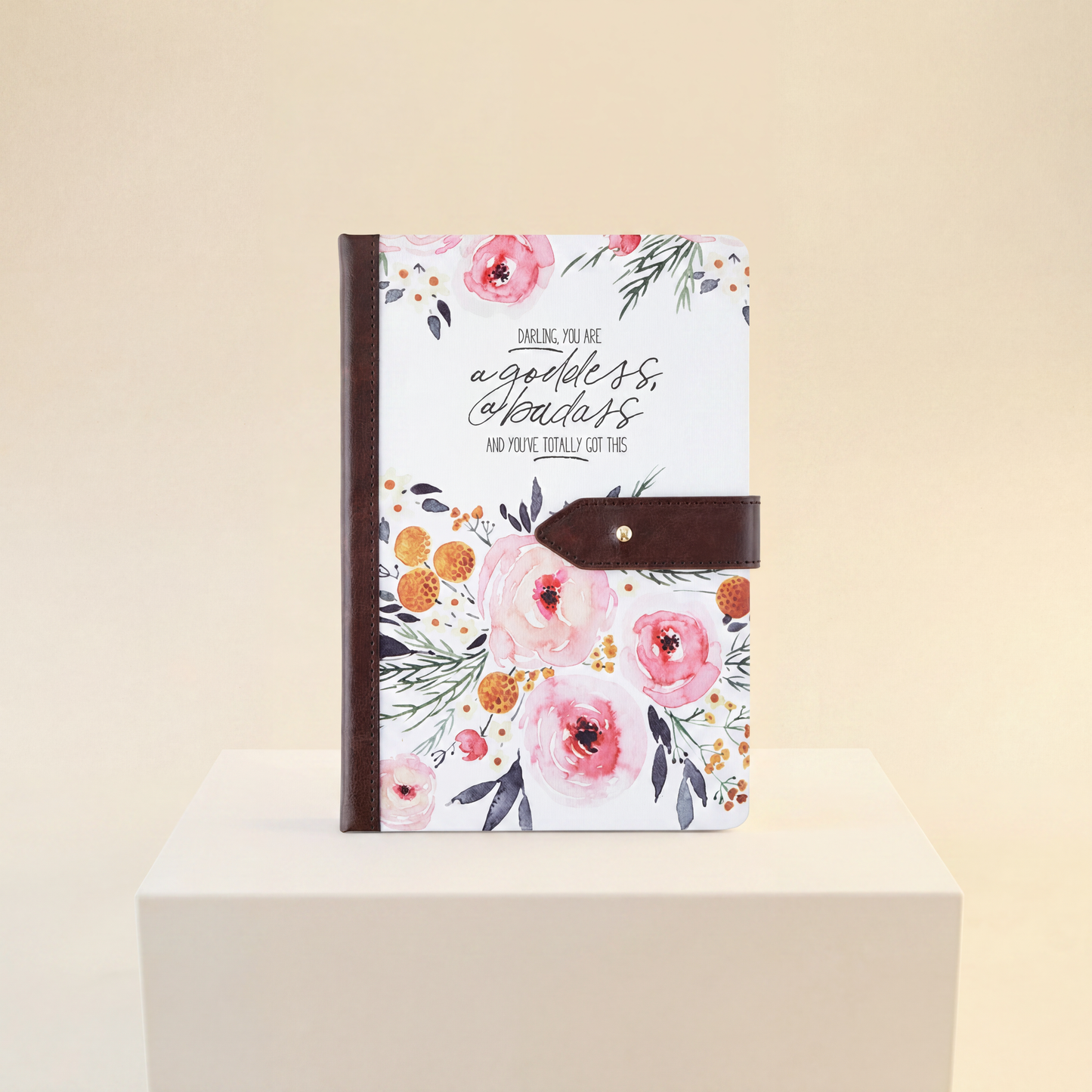 Floral notebook with motivational quote on a beige background