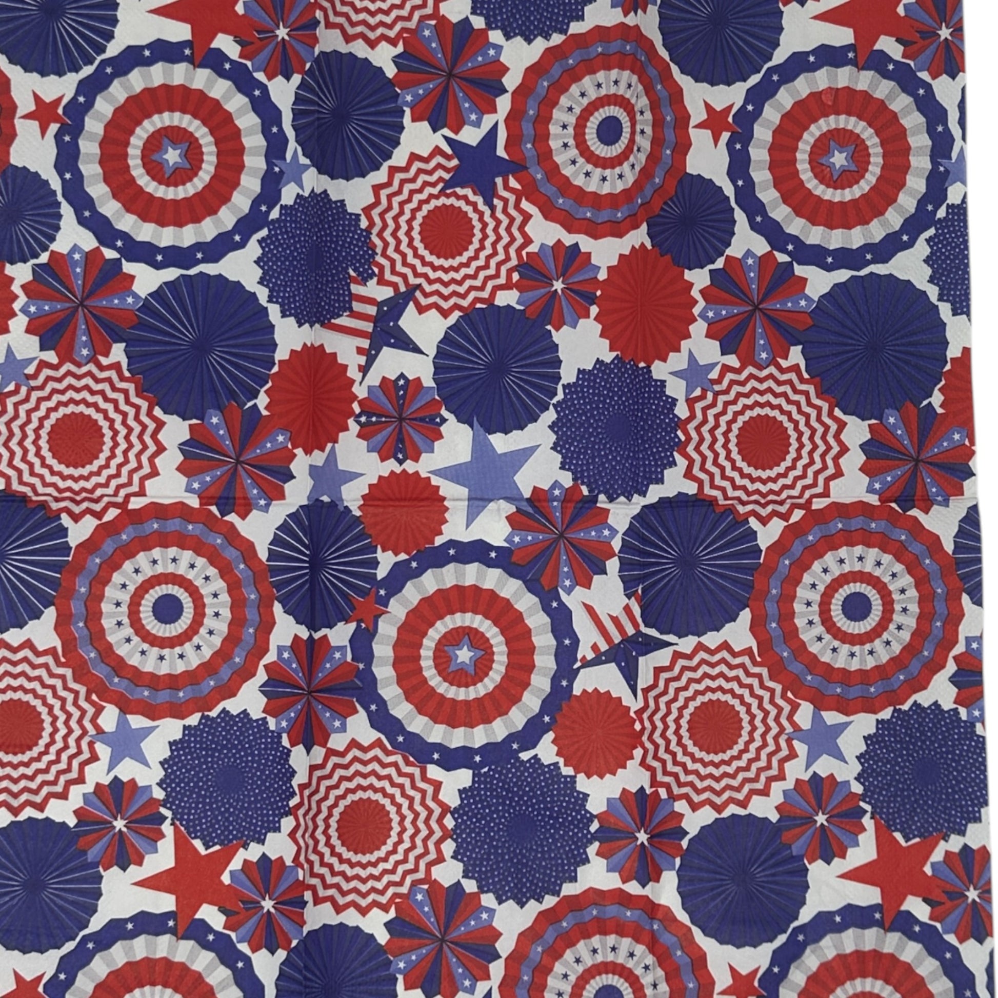 Patterned paper napkin with red, white, and blue geometric shapes on a white background