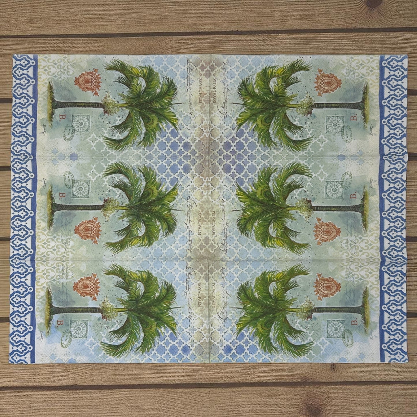 Royal palm cocktail size decoupage napkin with green tropical palm leaf design displayed unfolded