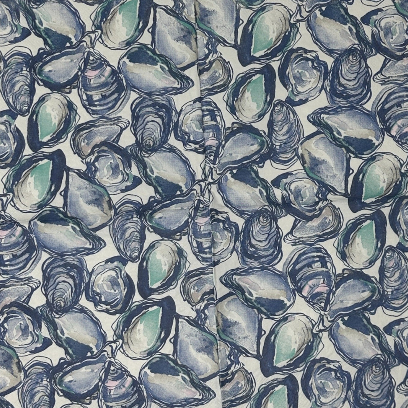 blue white napkin with oyster shells spread across the design
