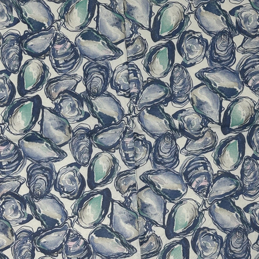 blue white napkin with oyster shells spread across the design