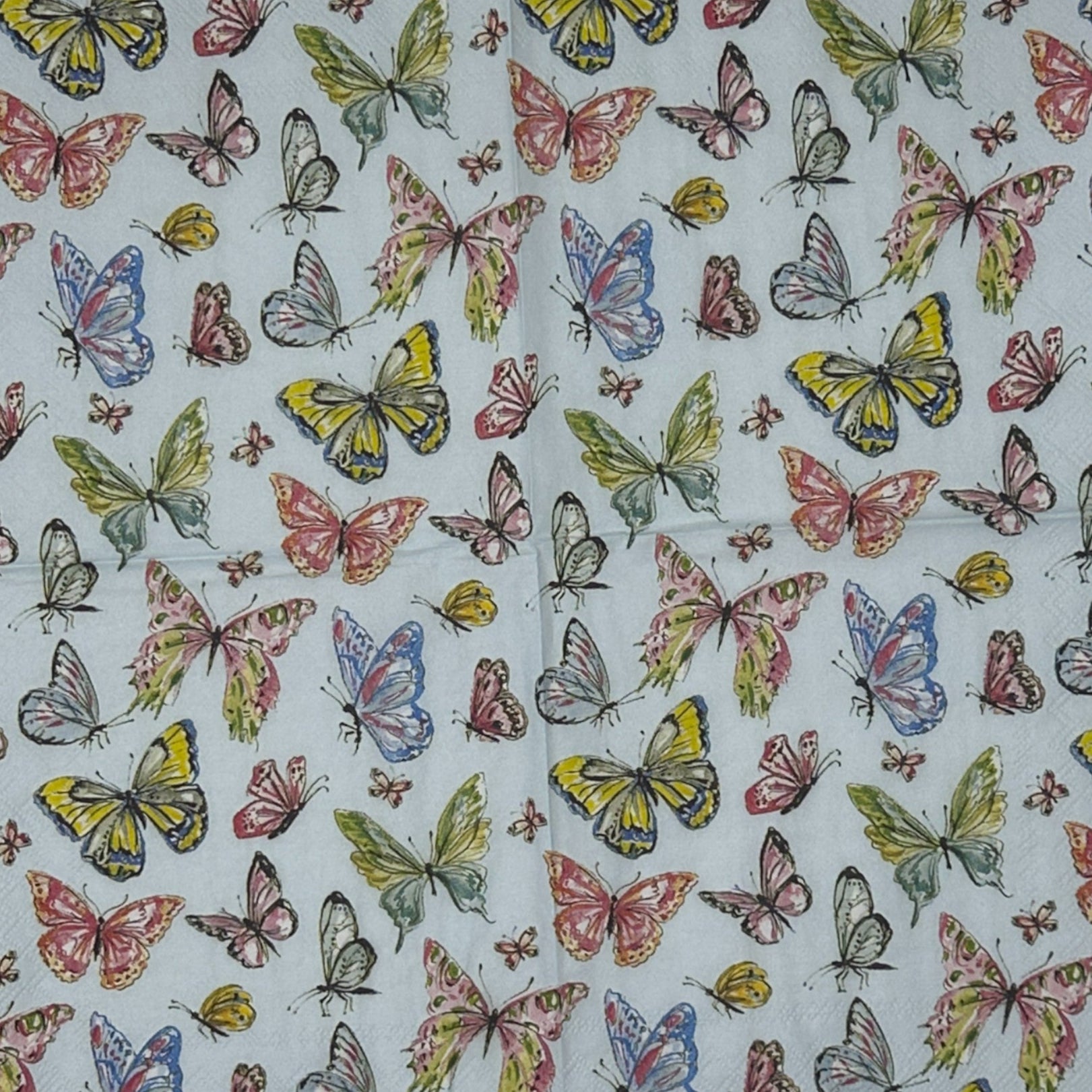 Butterfly patterned paper on a wooden surface