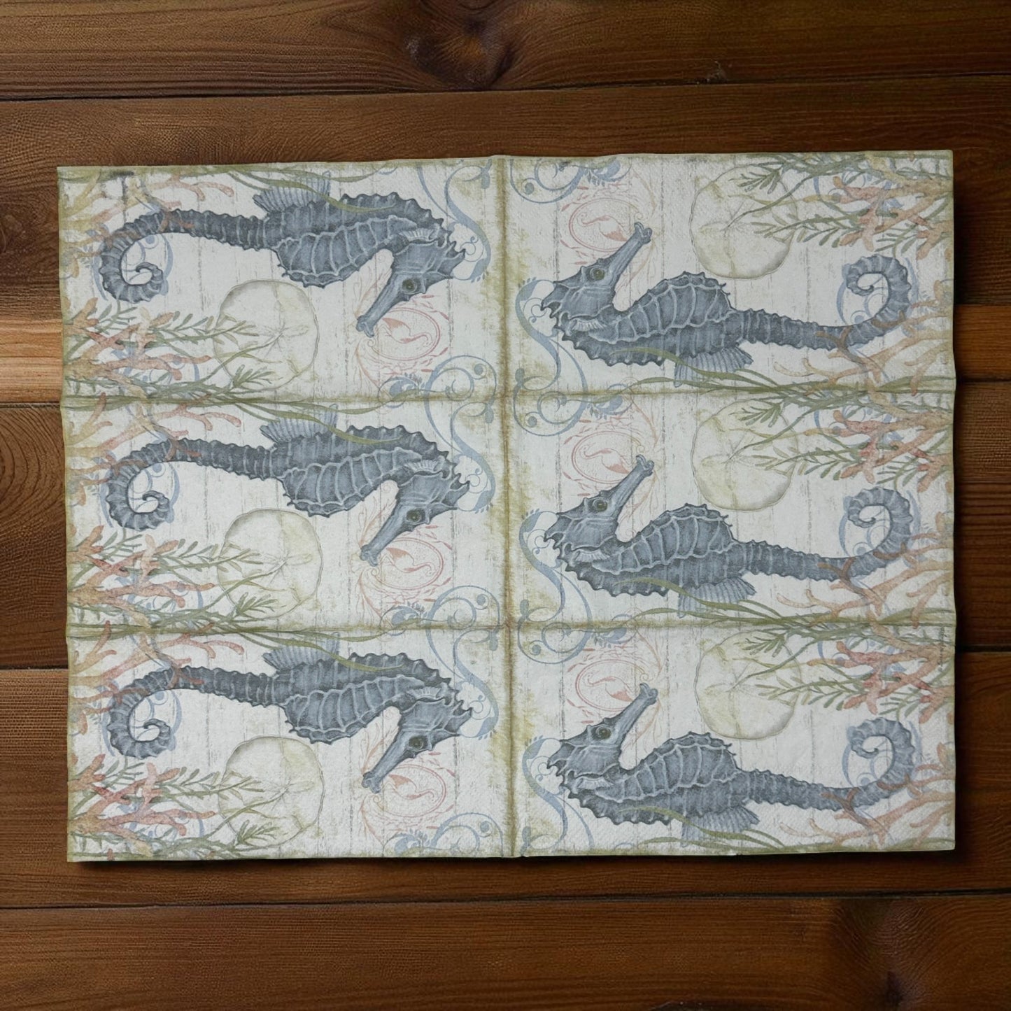 Seahorse cocktail size decoupage napkin with coastal nautical seahorse design displayed 