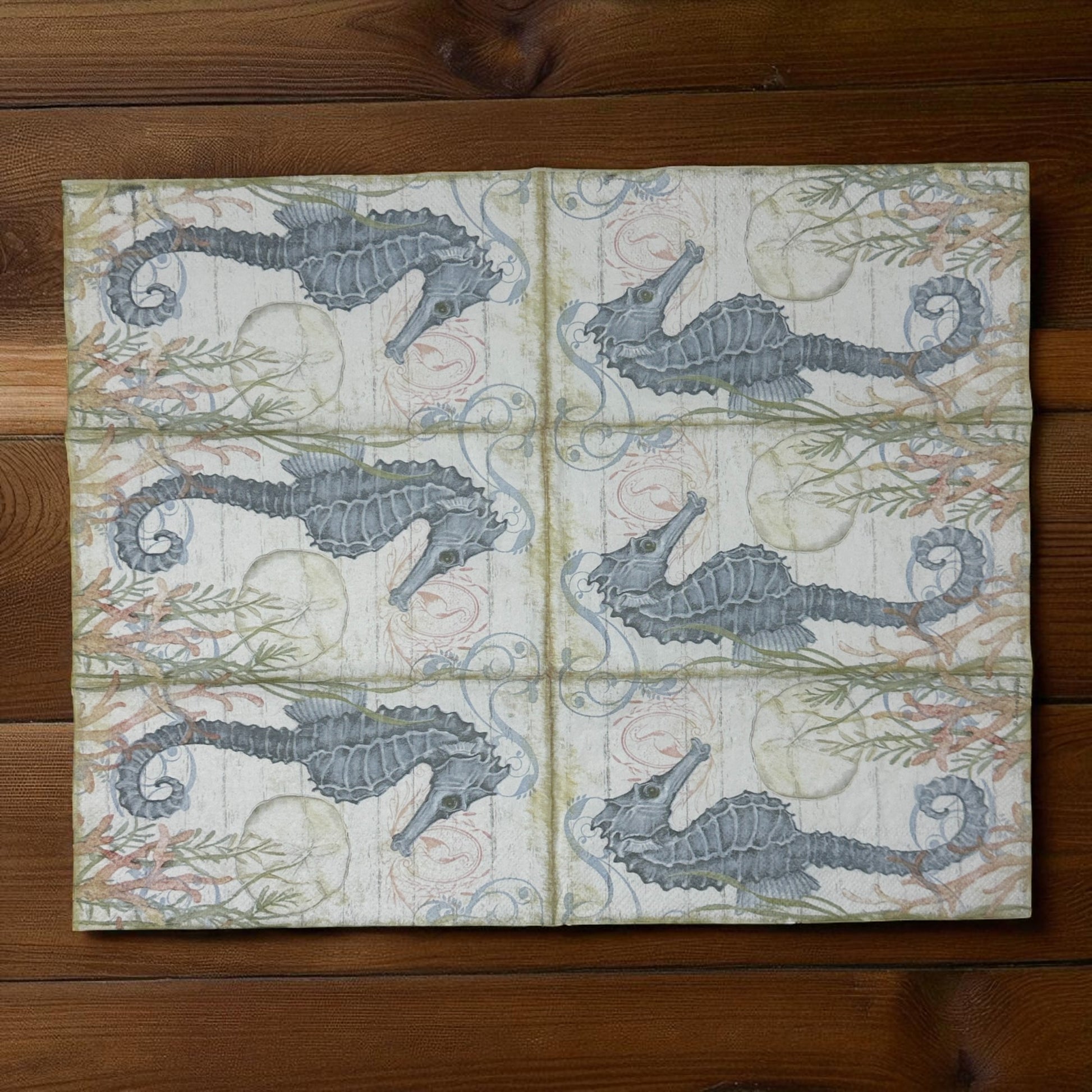 Seahorse cocktail size decoupage napkin with coastal nautical seahorse design displayed 