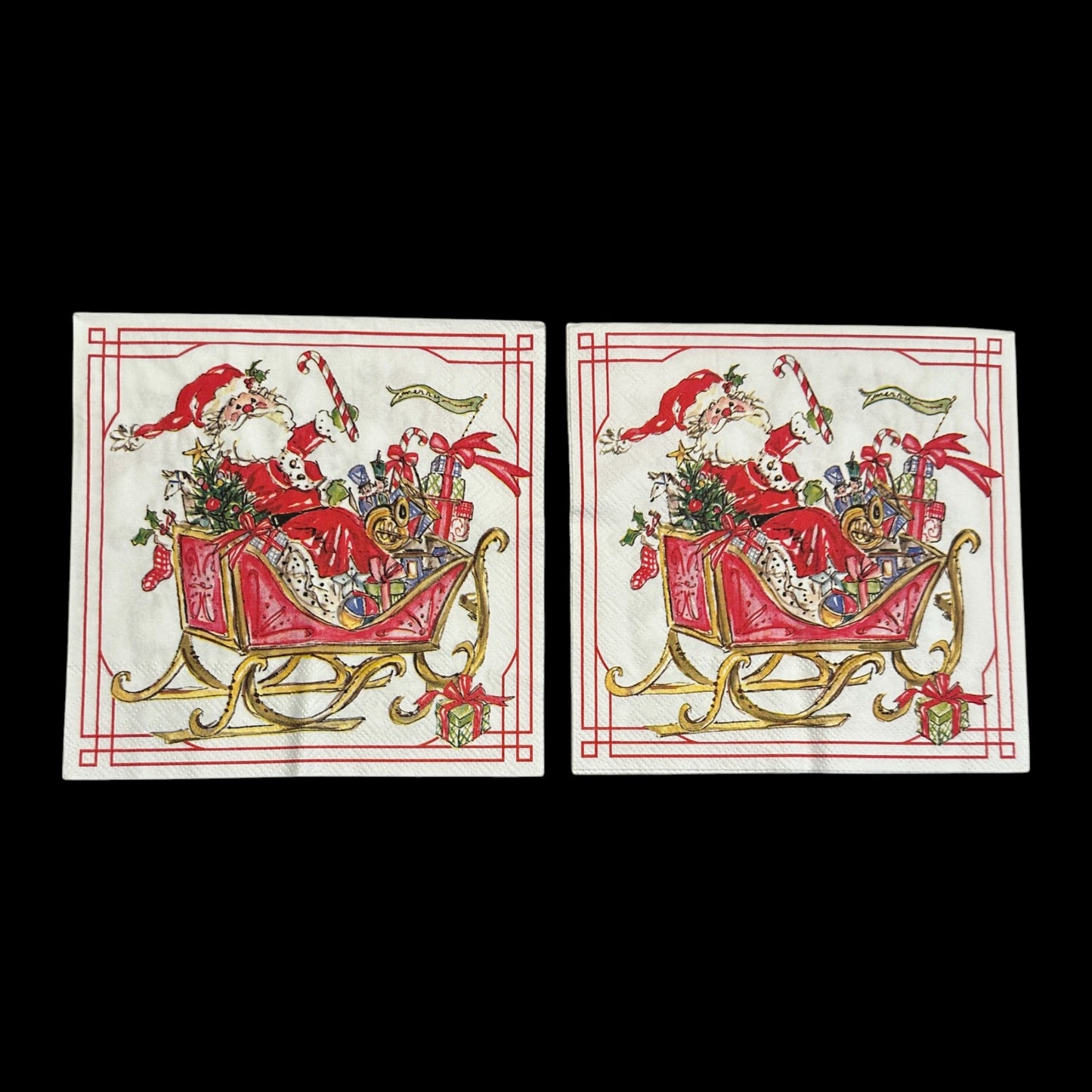 Two Luncheon size decoupage napkin featuring Santa Claus in a red sleigh filled with gifts, candy canes, and holly, bordered in red and gold for Christmas crafts.