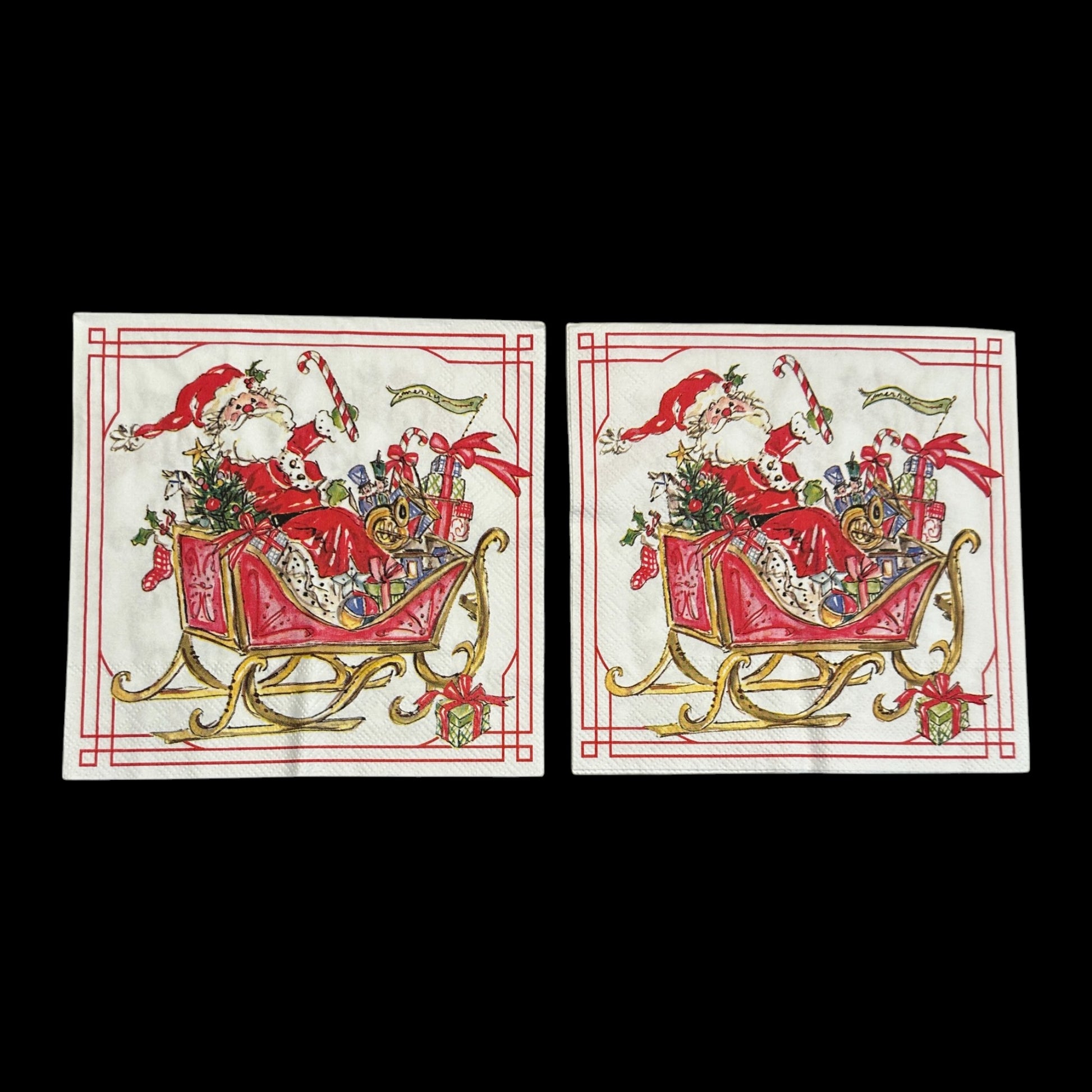 Two Luncheon size decoupage napkin featuring Santa Claus in a red sleigh filled with gifts, candy canes, and holly, bordered in red and gold for Christmas crafts.