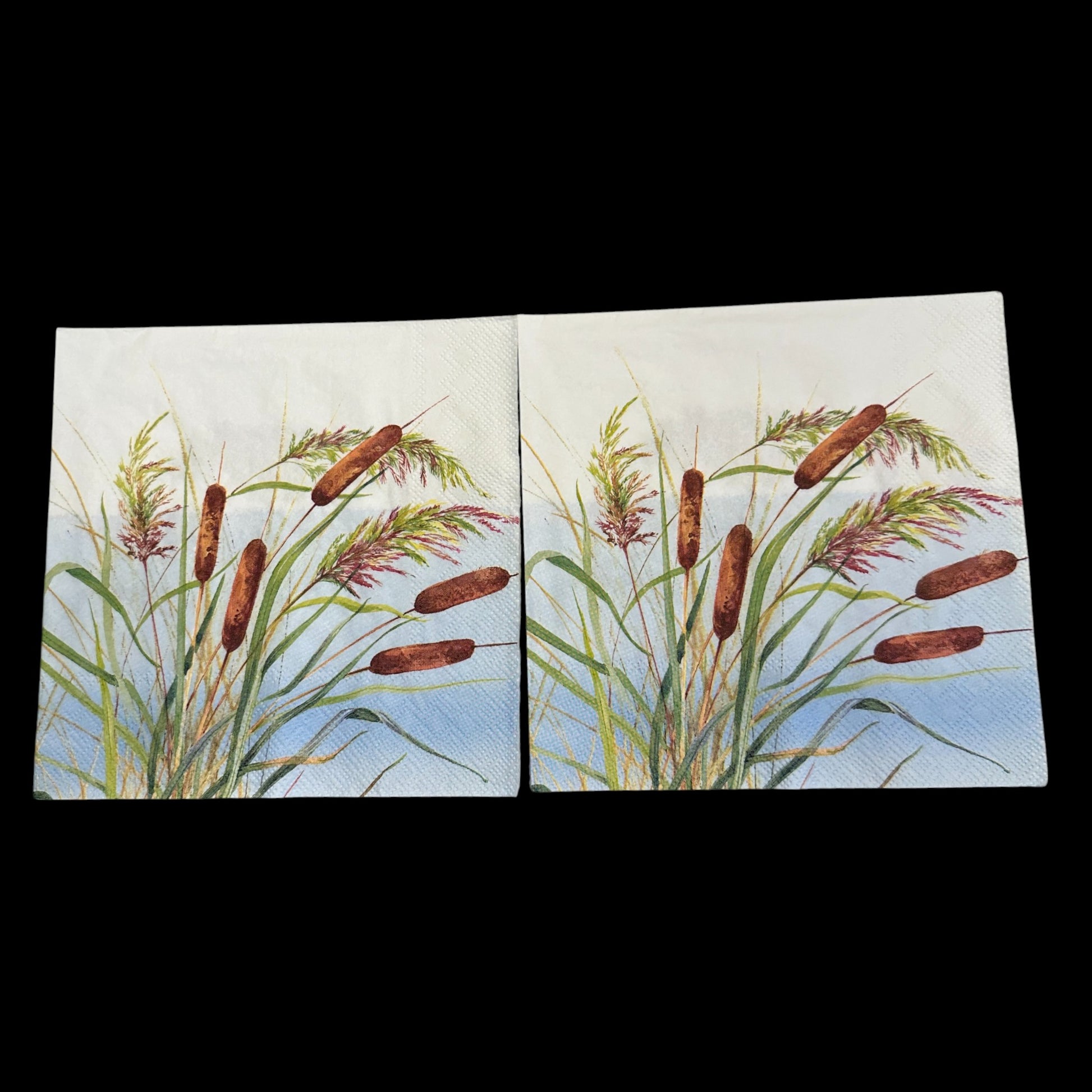 Two Luncheon size decoupage napkin featuring watercolor reeds and cattails in shades of green, brown, and purple on a blue sky background for nature crafts.