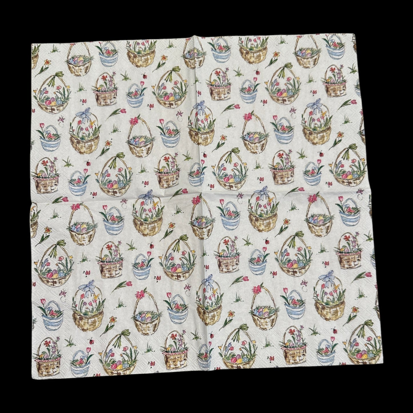 Unfolded Cocktail size decoupage napkin featuring Easter baskets filled with flowers, eggs, and ribbons on a white background for spring and Easter crafts.