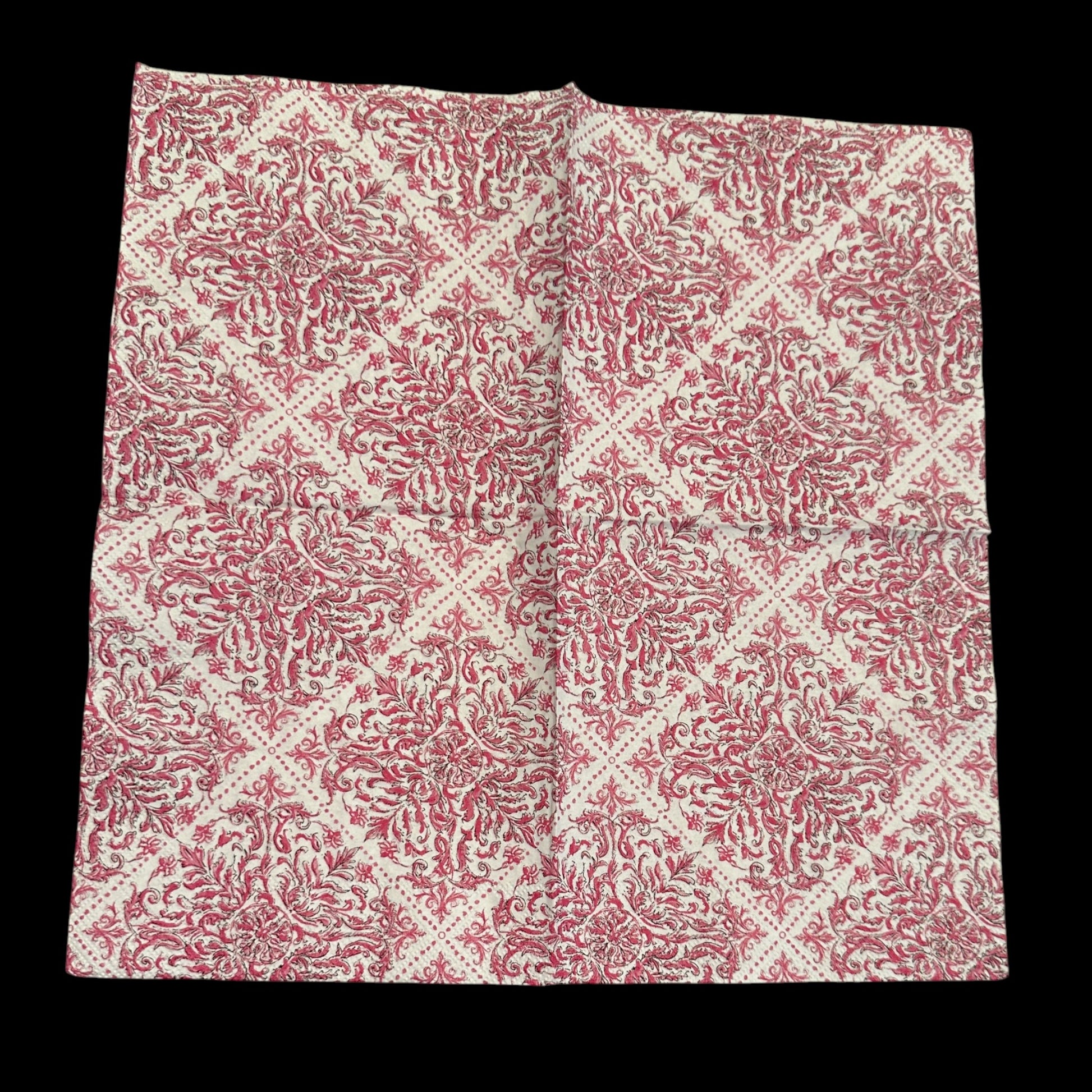 Open pink and white damask-style decoupage napkin with an ornate floral scroll pattern arranged in a repeating diamond design on a cream background.