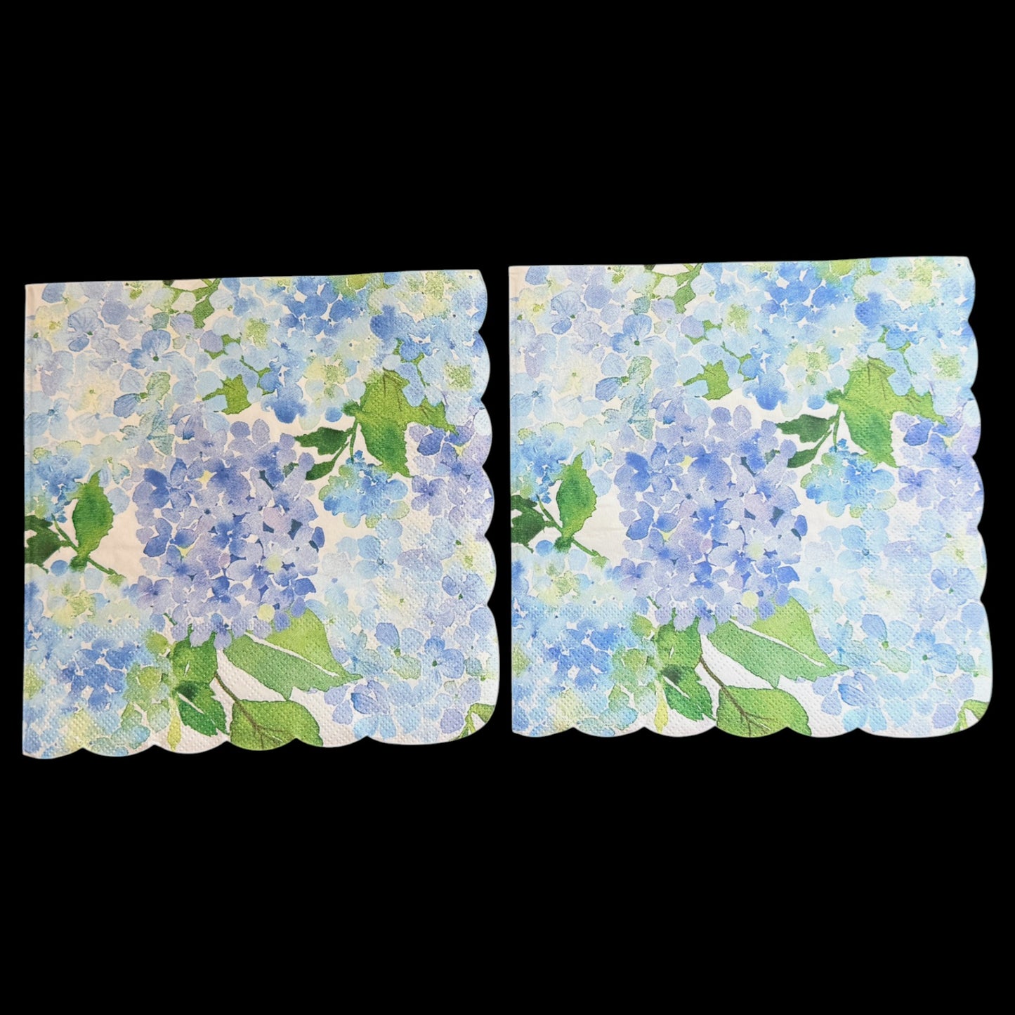 Two luncheon size decoupage paper napkins with scalloped edges featuring lush watercolor hydrangea clusters in periwinkle blue cornflower and violet with rich green leaves on a creamy white background set of 2