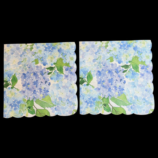 Two luncheon size decoupage paper napkins with scalloped edges featuring lush watercolor hydrangea clusters in periwinkle blue cornflower and violet with rich green leaves on a creamy white background set of 2