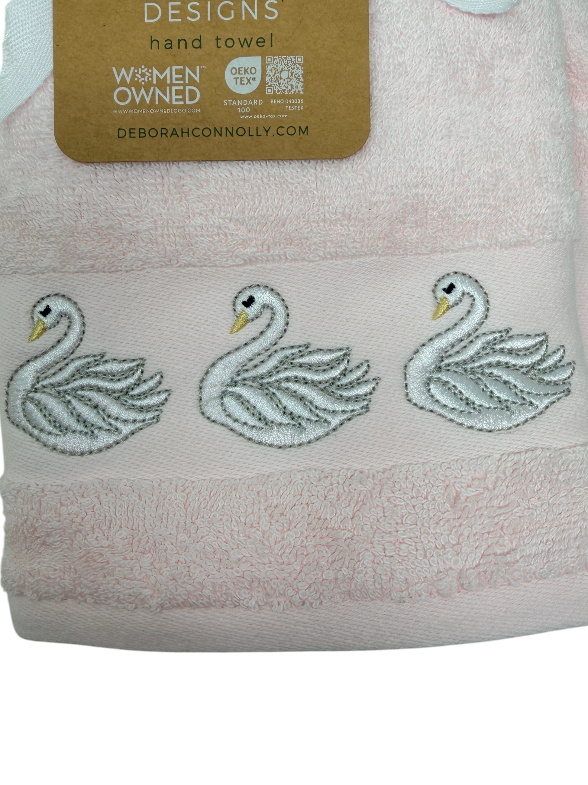 Set of two light‑pink hand towels with white embroidered swans by Deborah Connolly Designs, cotton‑lyocell blend