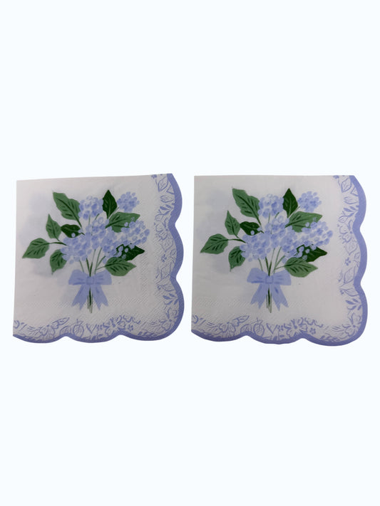Blue hydrangea scallop edge cocktail napkins with light blue flowers, leafy greens, and floral border