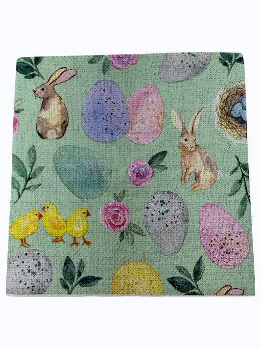 Pastel Easter cocktail napkin featuring bunnies, chicks, eggs, and floral designs on mint green background