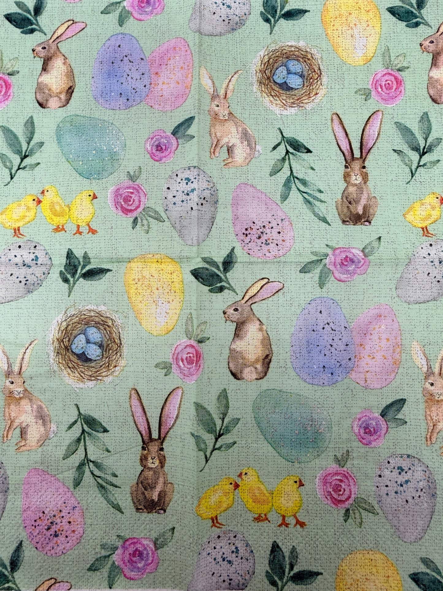 Pastel Easter cocktail napkin featuring bunnies, chicks, eggs, and floral designs on mint green background