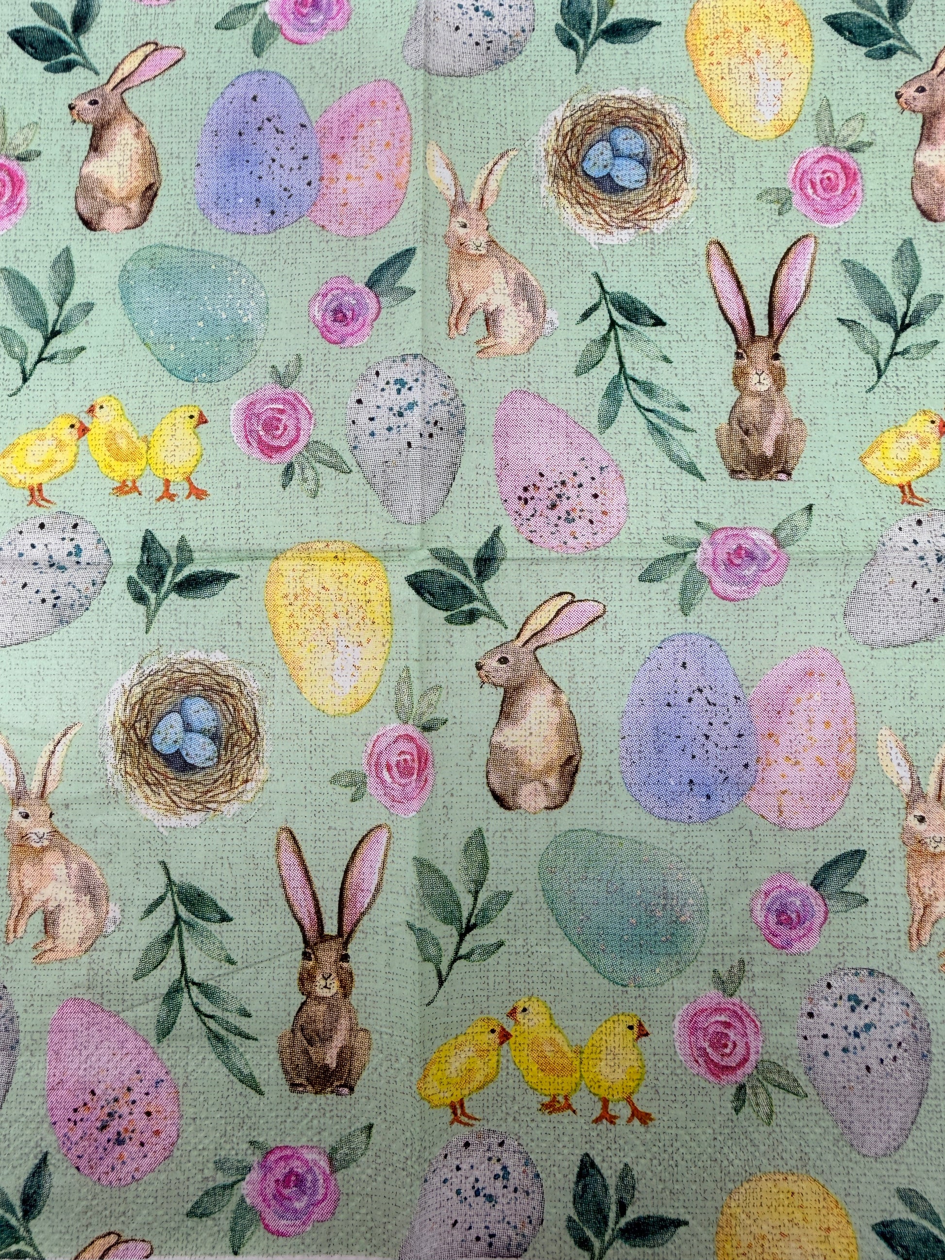 Pastel Easter cocktail napkin featuring bunnies, chicks, eggs, and floral designs on mint green background