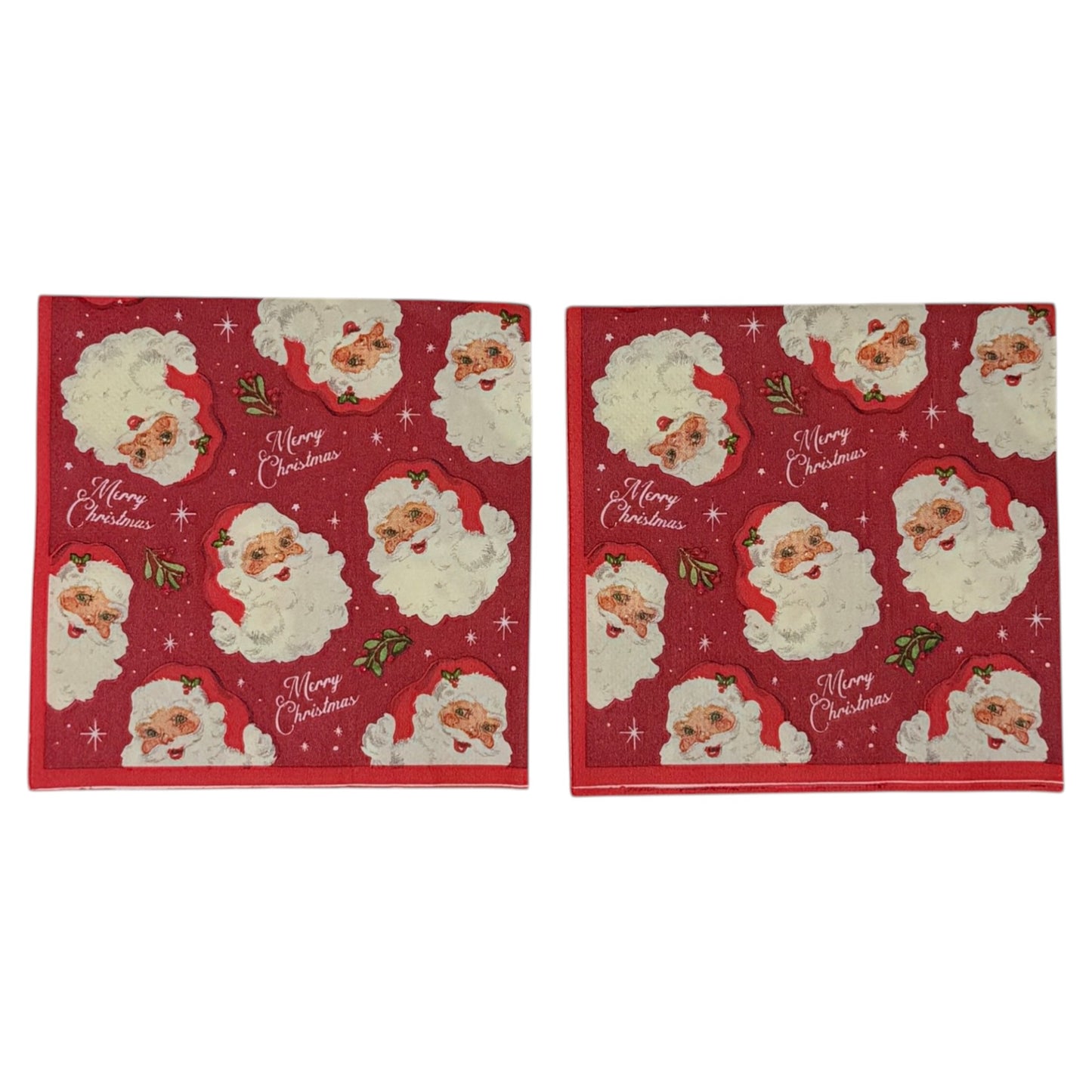 Cocktail size decoupage paper napkin featuring multiple jolly vintage Santa face portraits with fluffy white beards and red hats scattered across a deep crimson background with holly sprigs sparkling stars and Merry Christmas script set of 2