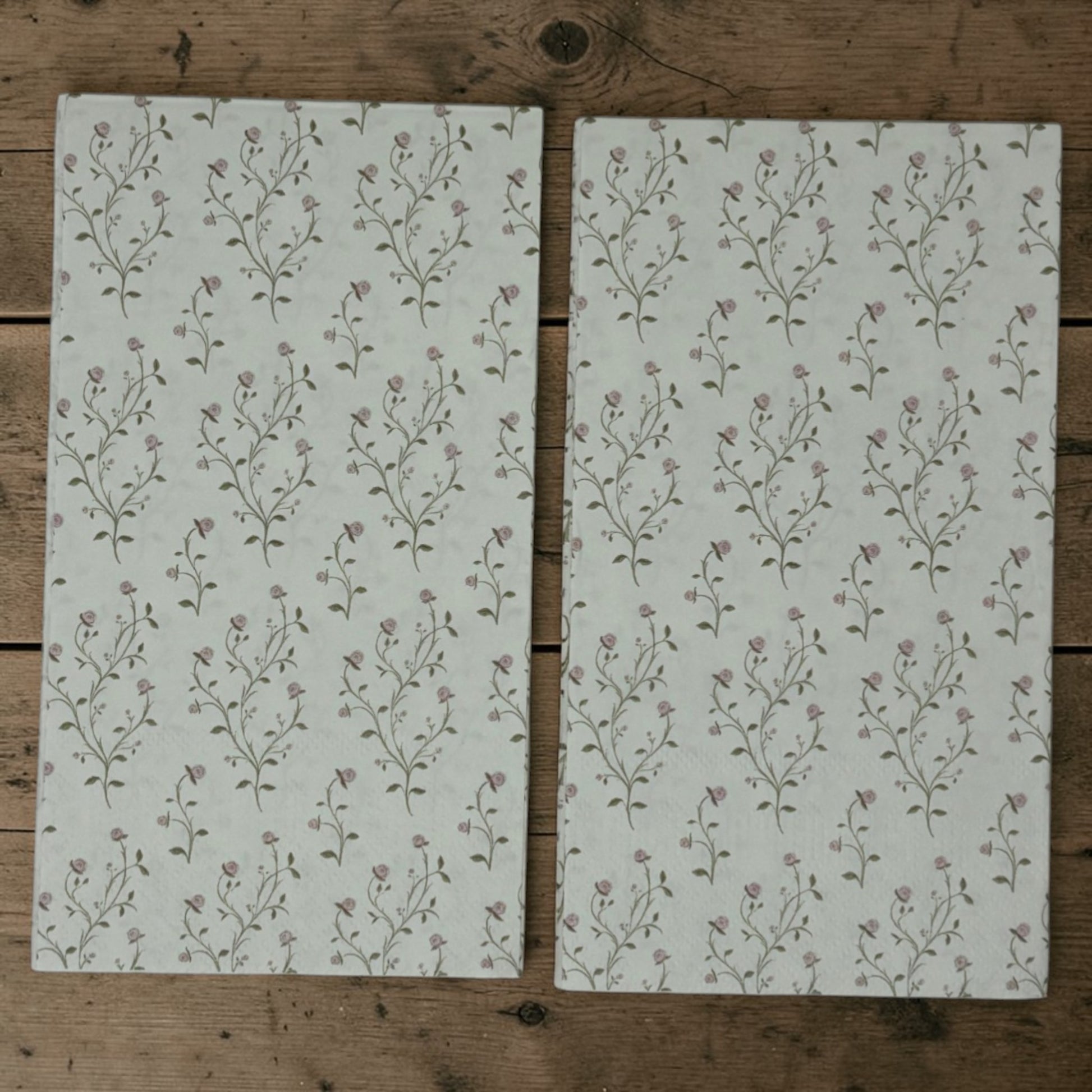 Guest size decoupage napkins featuring delicate trailing rose vine cascades with tiny blush pink rosebuds and soft olive gold leaves on a warm creamy ivory background set of 2