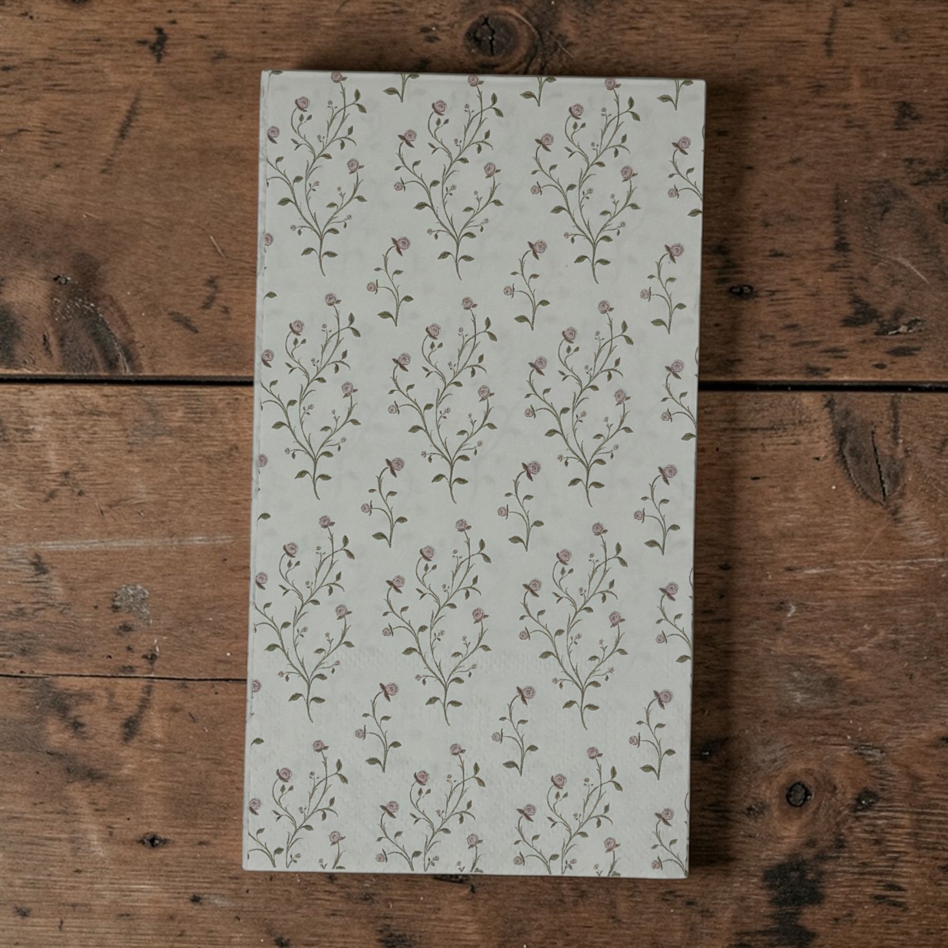 Guest size decoupage napkins featuring delicate trailing rose vine cascades with tiny blush pink rosebuds and soft olive gold leaves on a warm creamy ivory background set of 2