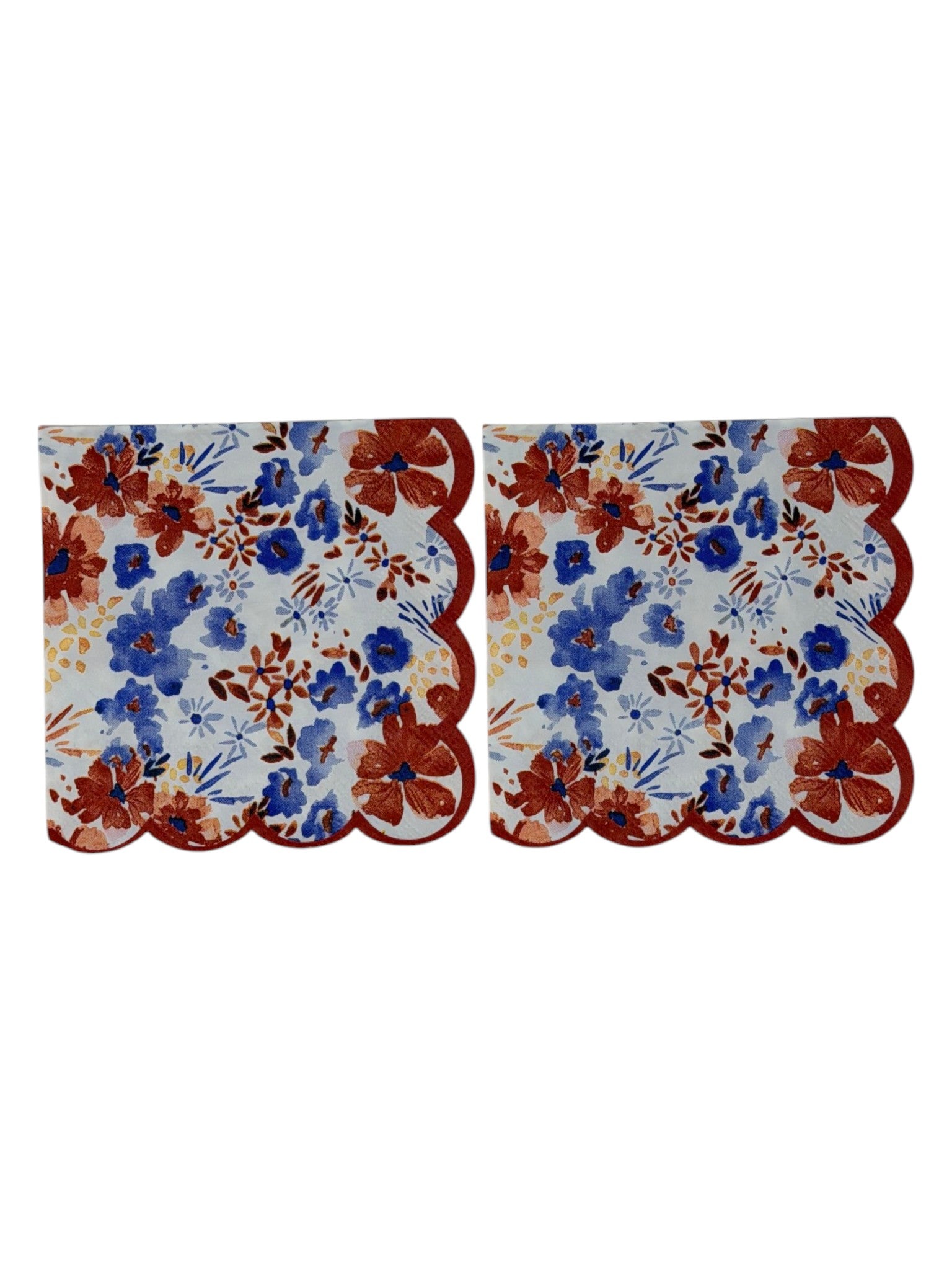 Cocktail-size decoupage paper napkin with a distinctive red scalloped edge featuring a watercolor floral print of cornflower blue blooms, deep rust red flowers, soft blush pink petals, and golden accents on a crisp white background, photographed on a white surface.