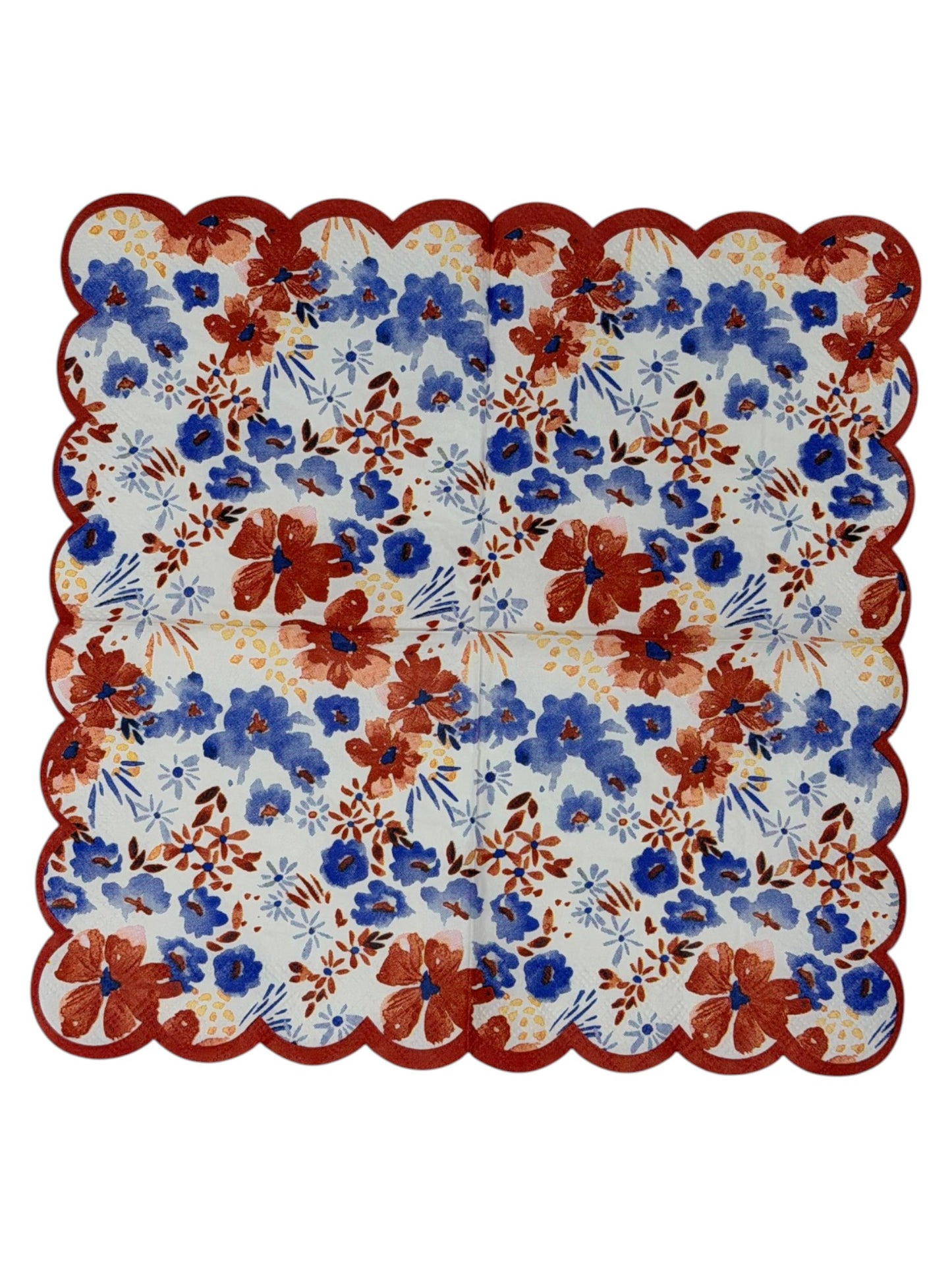Cocktail-size decoupage paper napkin with a distinctive red scalloped edge featuring a watercolor floral print of cornflower blue blooms, deep rust red flowers, soft blush pink petals, and golden accents on a crisp white background, photographed on a white surface.