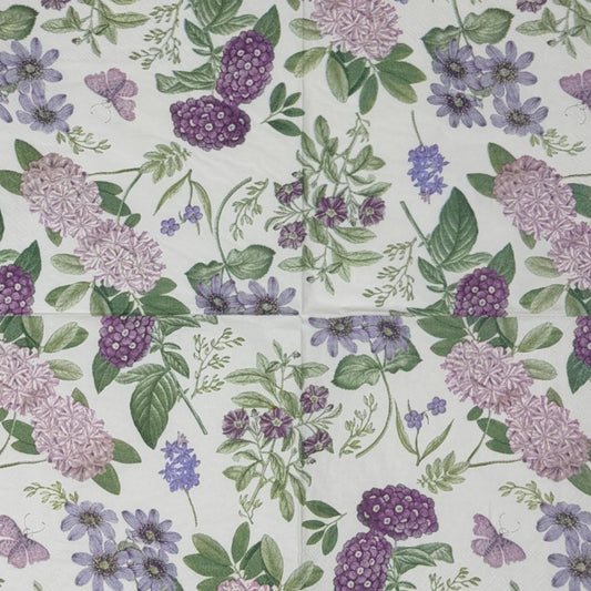 Luncheon-size decoupage paper napkin featuring a vintage botanical illustration print of lavender and purple lilac clusters, periwinkle blue anemones, mauve wildflowers, tiny purple butterflies, and green leaves on a white background with gold foil border stripes, photographed against a white wall.