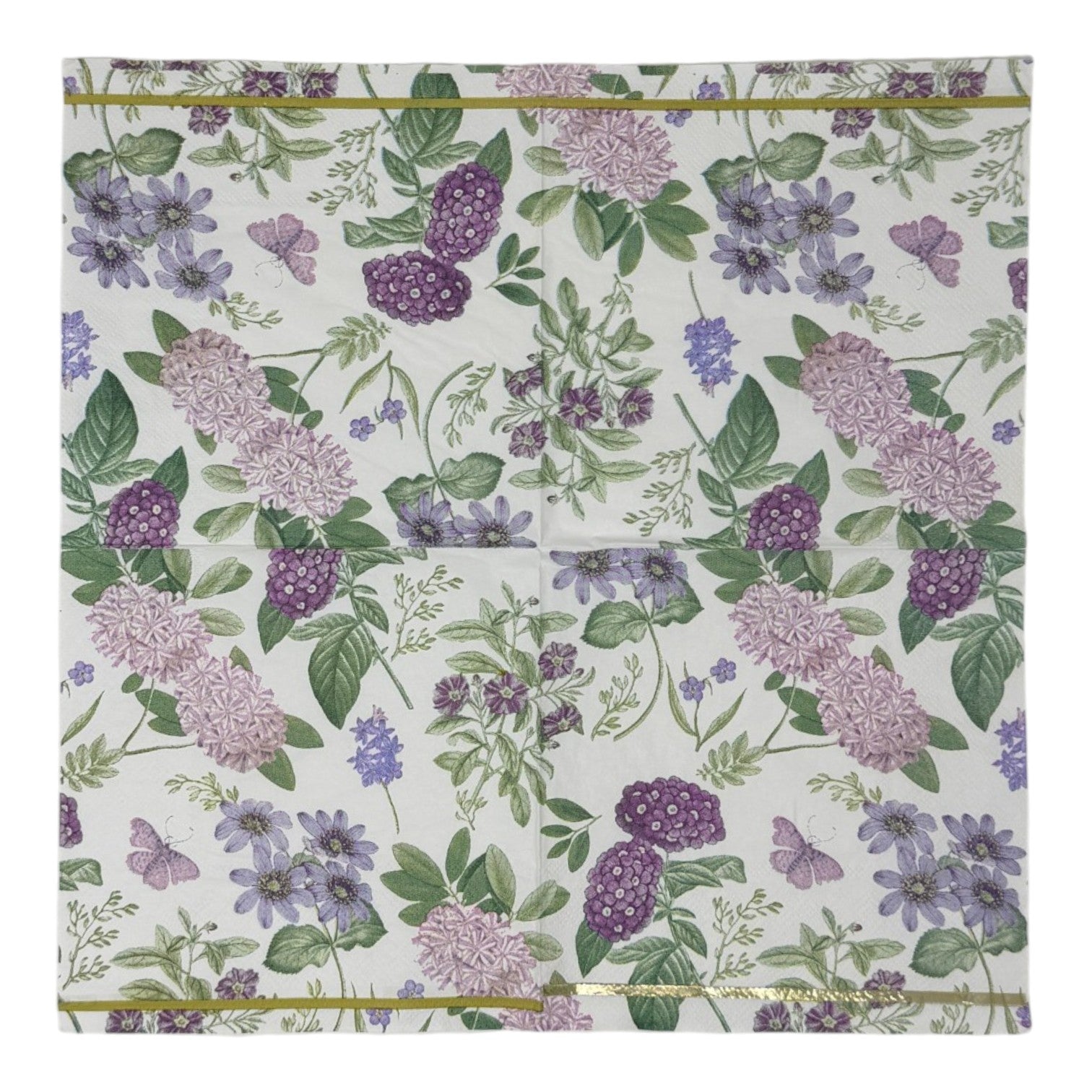 Luncheon-size decoupage paper napkin featuring a vintage botanical illustration print of lavender and purple lilac clusters, periwinkle blue anemones, mauve wildflowers, tiny purple butterflies, and green leaves on a white background with gold foil border stripes, photographed against a white wall.