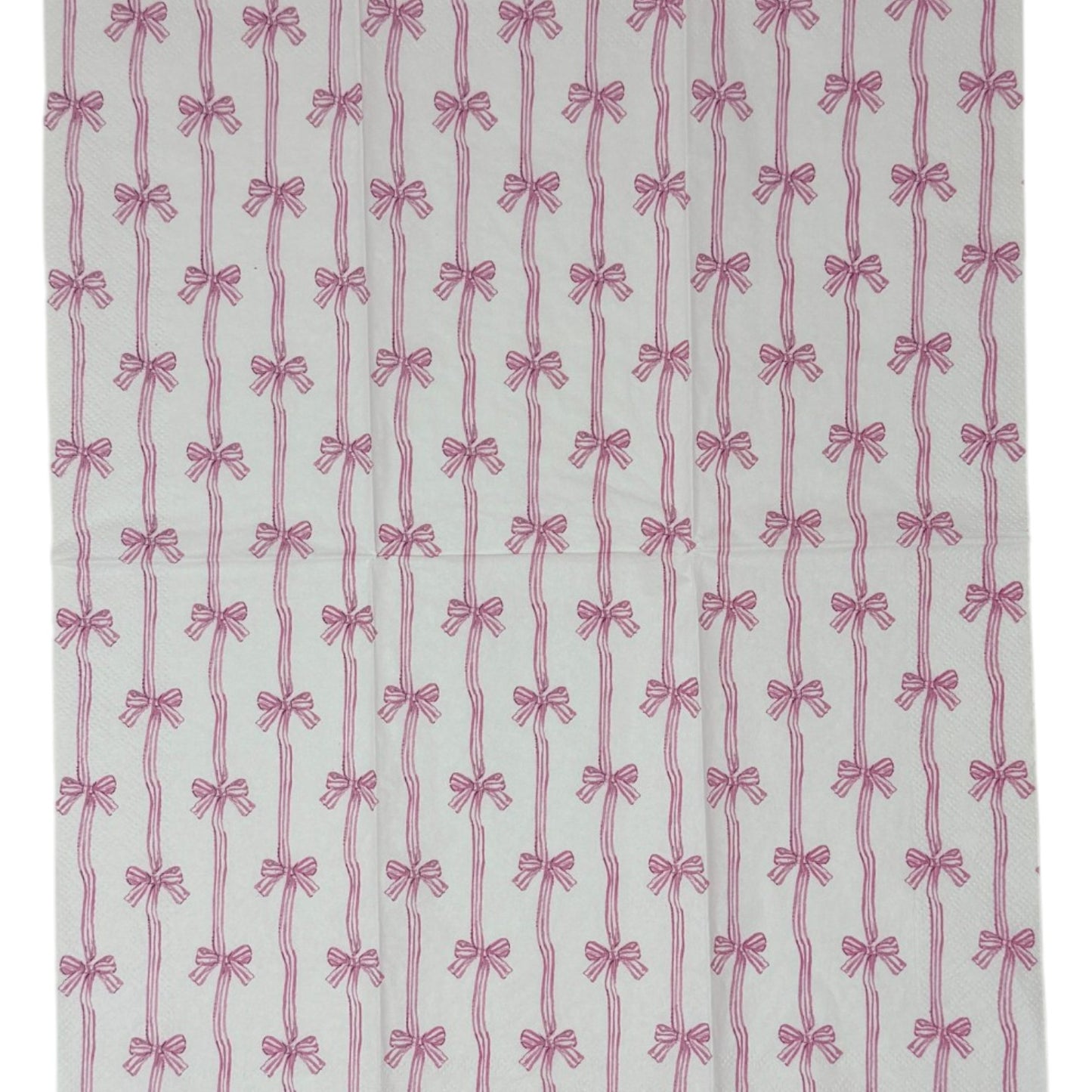 Two guest-size decoupage paper napkins featuring an all-over print of vertical wavy stripes with small striped bows tied at intervals in dusty pink and mauve on a crisp white background, photographed on a white surface.