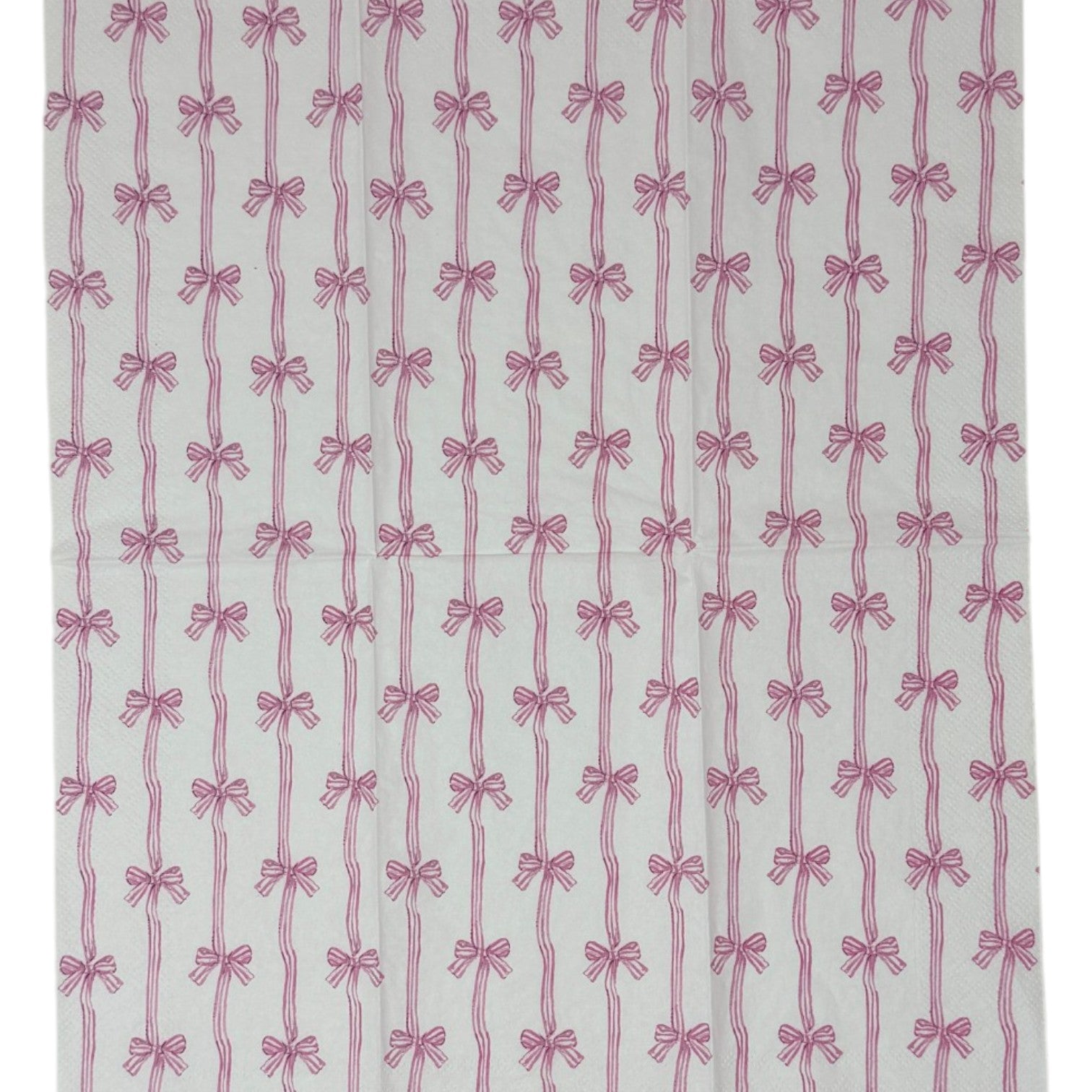 Two guest-size decoupage paper napkins featuring an all-over print of vertical wavy stripes with small striped bows tied at intervals in dusty pink and mauve on a crisp white background, photographed on a white surface.