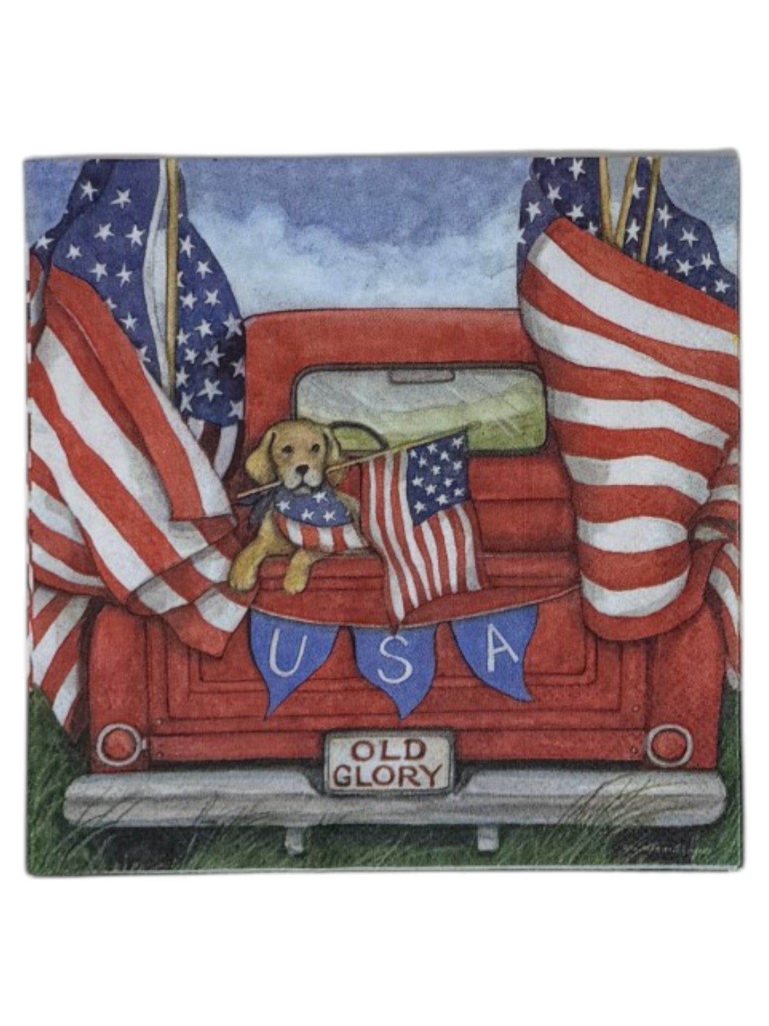 Luncheon size decoupage paper napkin featuring a golden retriever in a flag bandana peeking over the tailgate of a classic red pickup truck flying large American flags with a USA bunting banner and Old Glory license plate set of 2