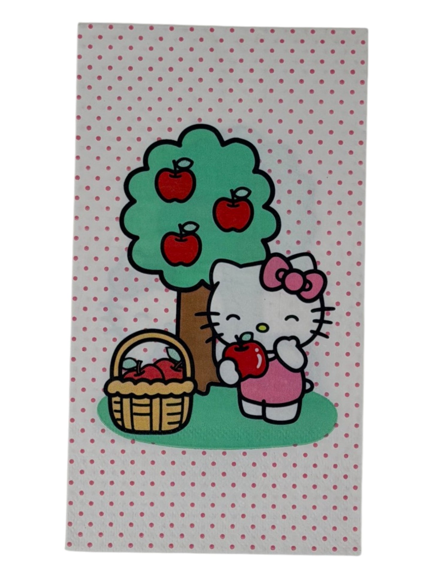Guest-size decoupage paper napkin featuring a centered illustration of Hello Kitty in a pink bow standing beside a green apple tree with red apples and a wicker basket of apples on a white polka dot background, photographed on a white surface.