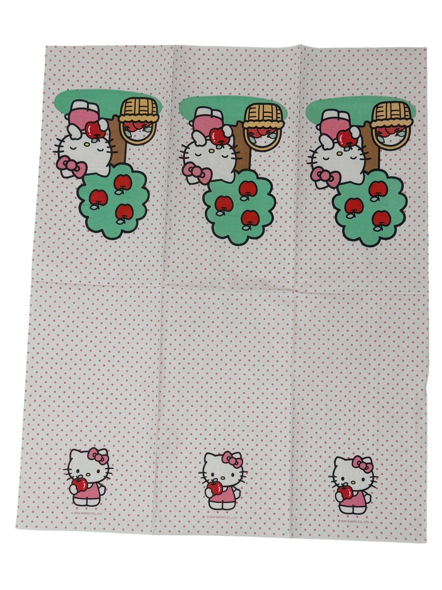Guest-size decoupage paper napkin featuring a centered illustration of Hello Kitty in a pink bow standing beside a green apple tree with red apples and a wicker basket of apples on a white polka dot background, photographed on a white surface.