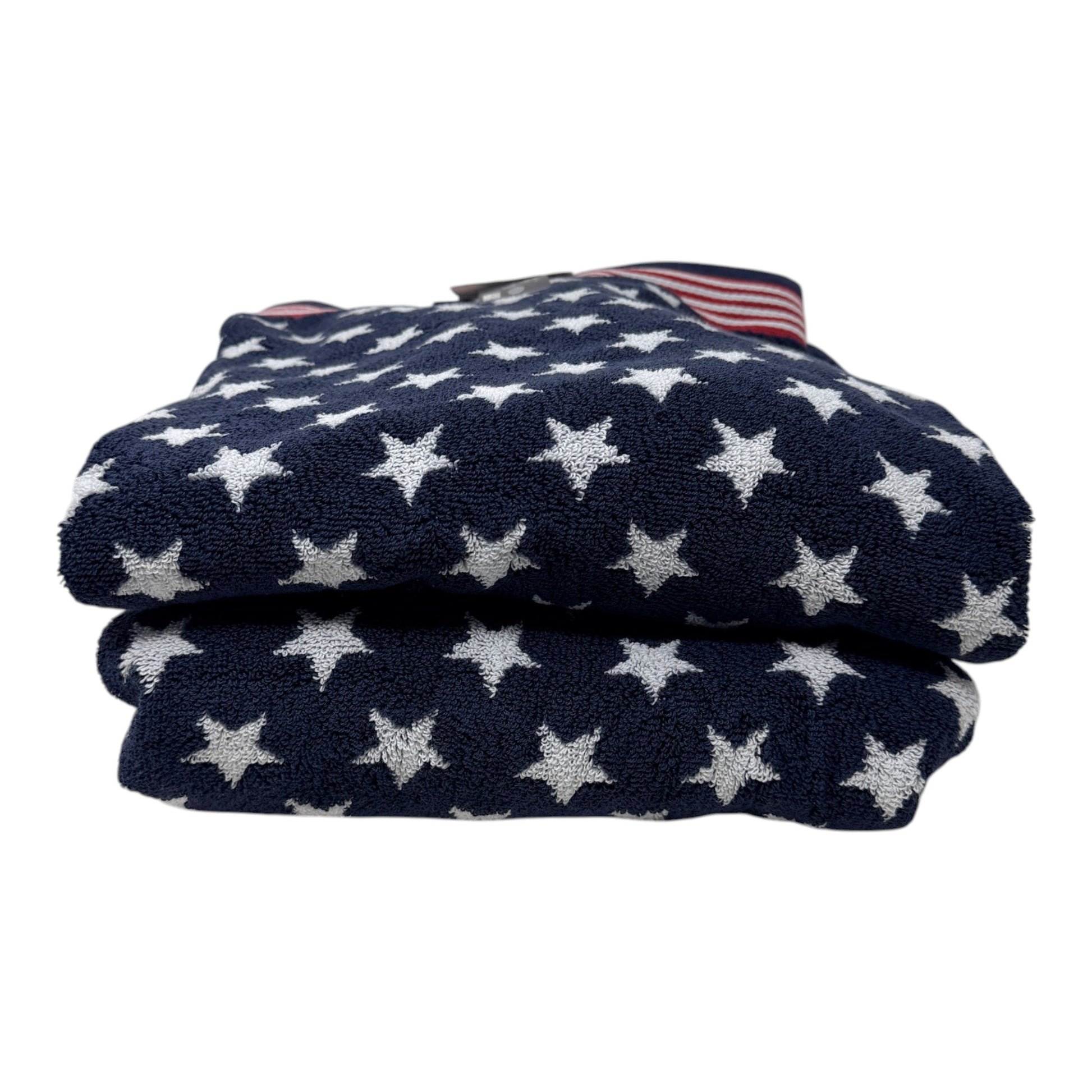 Set of two Brooks Brothers navy blue bath towels with all-over white star jacquard pattern and red and white stripe border, 30x56 inches, new with tags