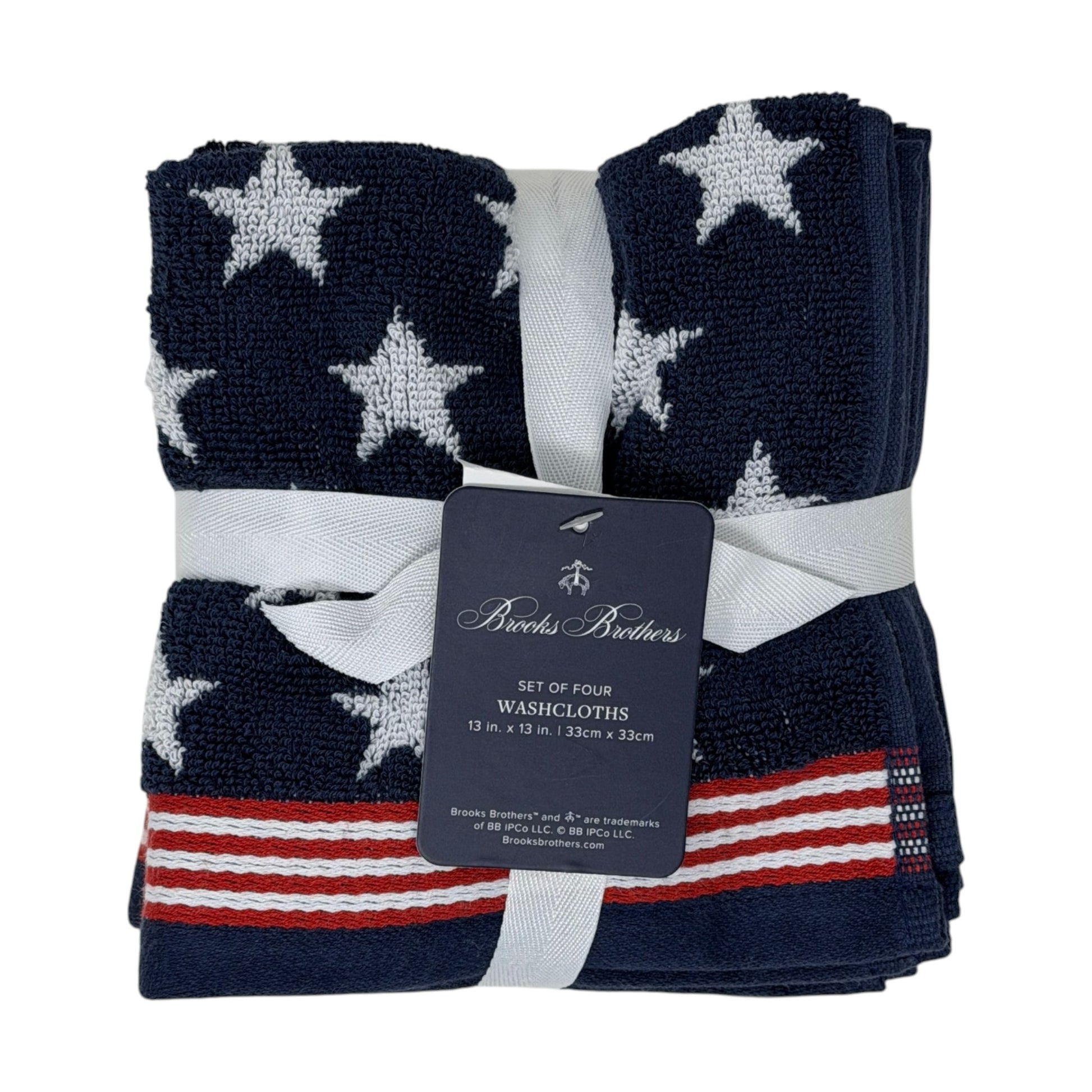 Set of four Brooks Brothers navy blue washcloths with all-over white star jacquard pattern and red and white stripe border, 13x13 inches, new with tags