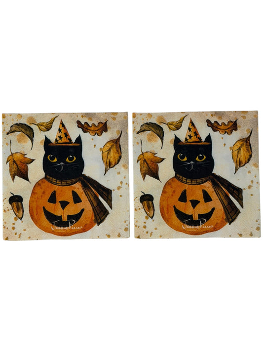Cocktail-size decoupage paper napkin featuring a vintage illustration of a black cat in a gold star witch hat and plaid cape perched on a grinning orange jack-o-lantern surrounded by golden autumn leaves and an acorn on a warm aged parchment background with watercolor ink accents, photographed on a white surface.