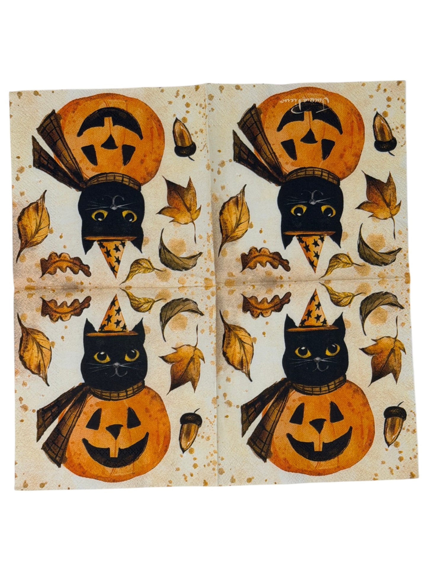 Cocktail-size decoupage paper napkin featuring a vintage illustration of a black cat in a gold star witch hat and plaid cape perched on a grinning orange jack-o-lantern surrounded by golden autumn leaves and an acorn on a warm aged parchment background with watercolor ink accents, photographed on a white surface.