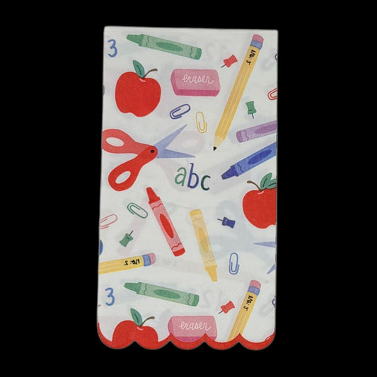 Guest-size decoupage paper napkin featuring a colorful all-over print of school supplies including red scissors crayons red apples pink erasers paper clips push pins pencils and abc 123 lettering on a white background with a red scalloped edge border, photographed on a black surface.